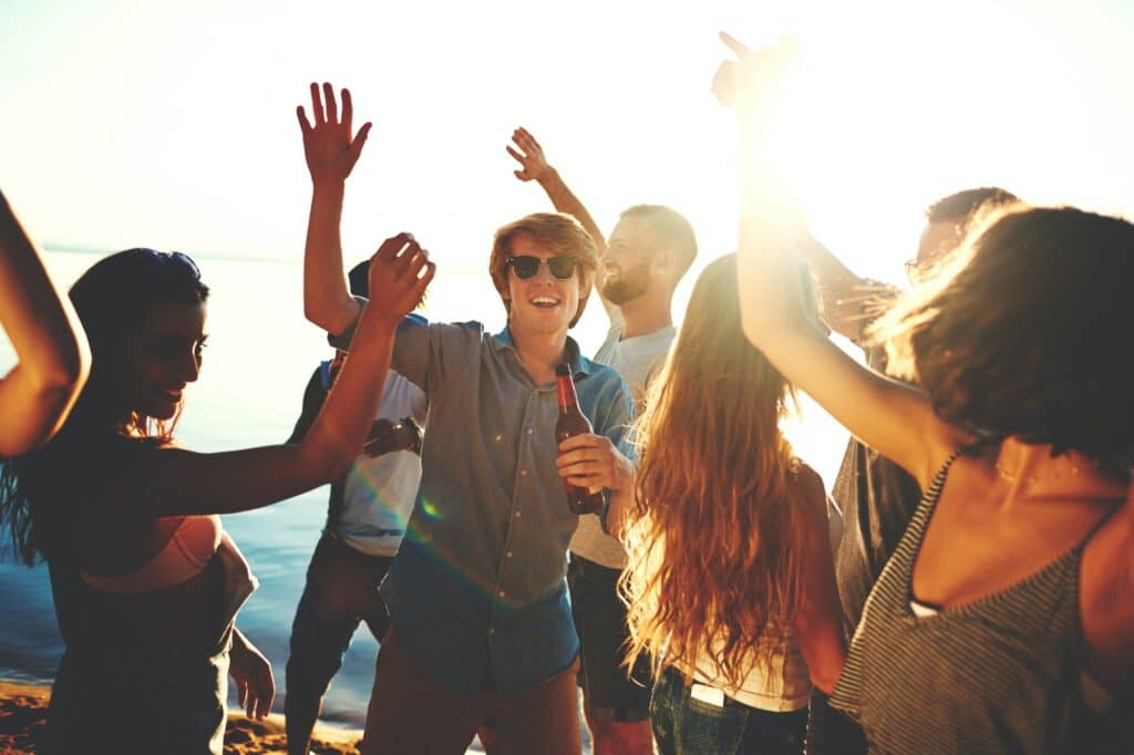 Friends dancing on the beach to music supplied by Good Company Entertainment Group who is based out of Edmonton