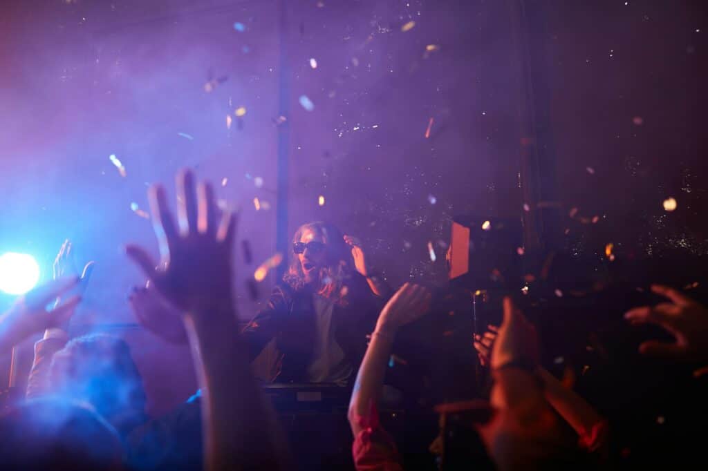 DJ performing for a crowd at an event that used Good Company Entertainment Group's vendor management services