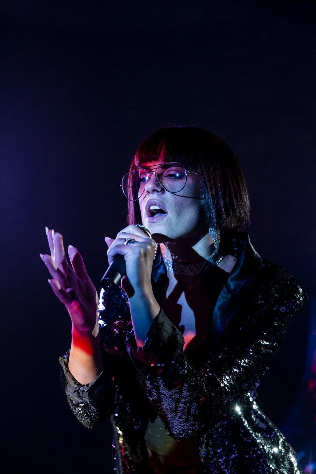 Woman singing on stage because of booking assistance from Good Company Entertainment Group's artist support and management services in Edmonton